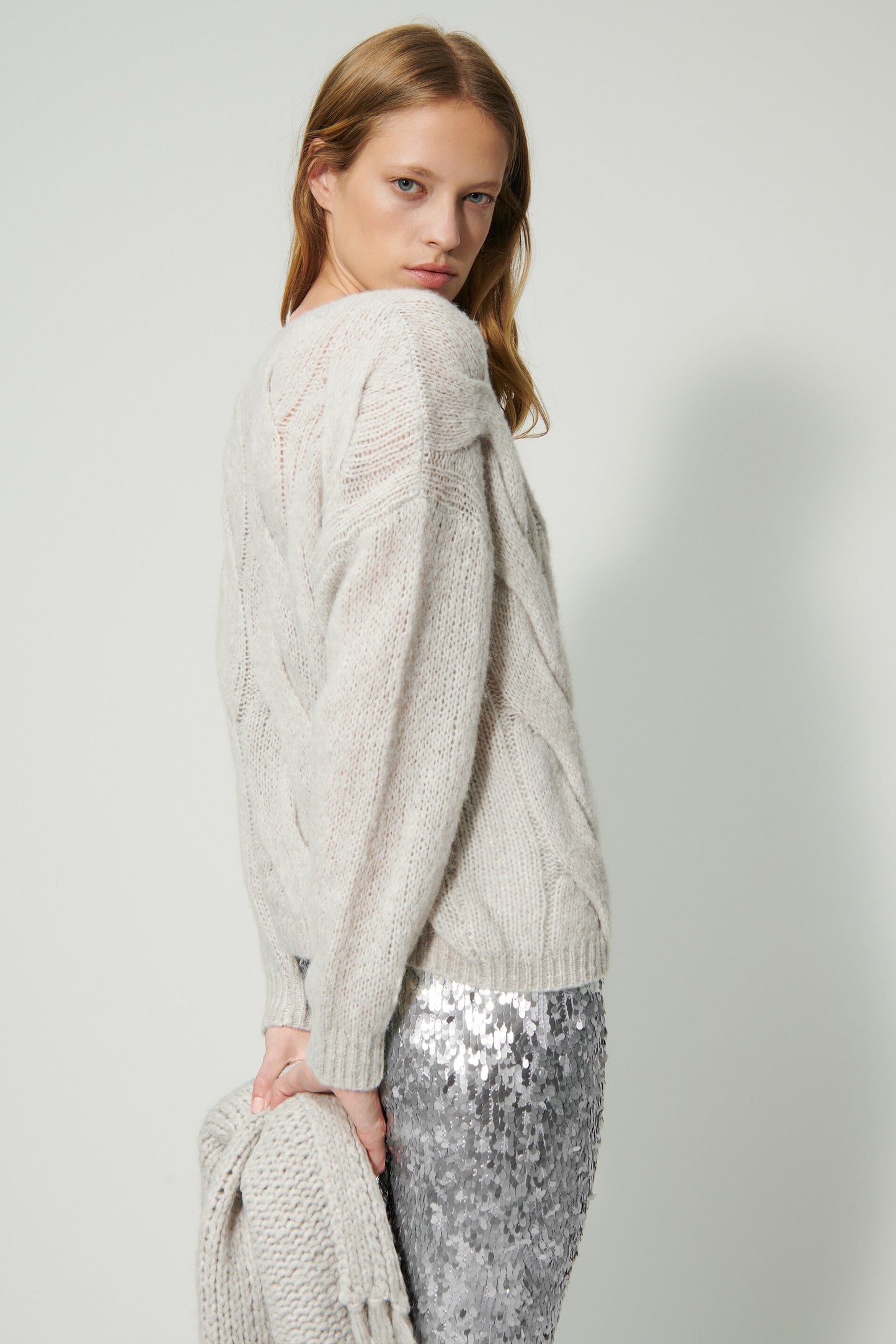 Knitted sweater with cable pattern