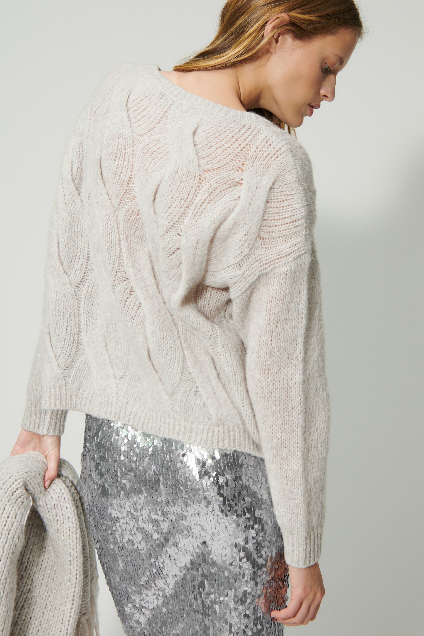 Knitted sweater with cable pattern