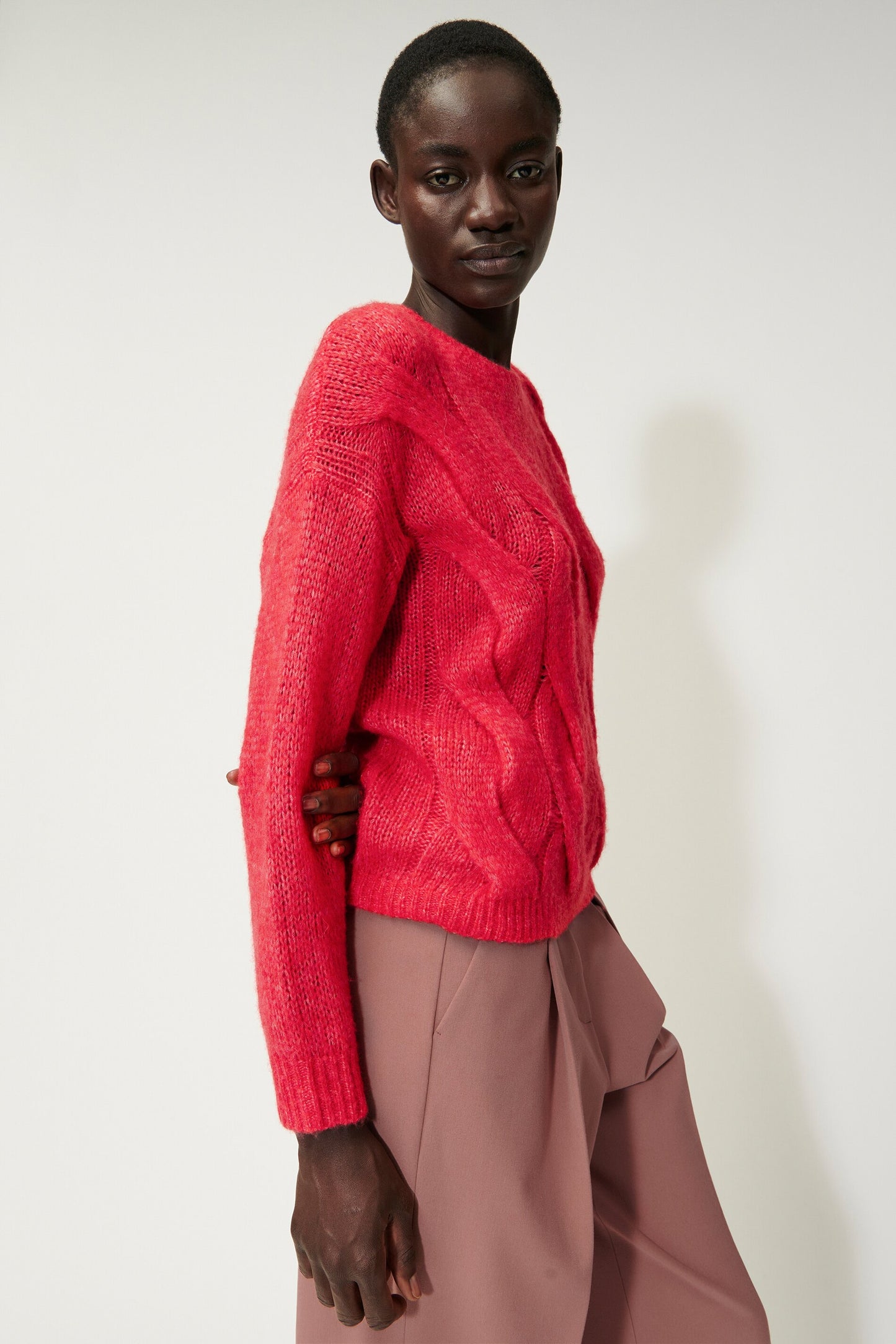 Knitted sweater with cable pattern